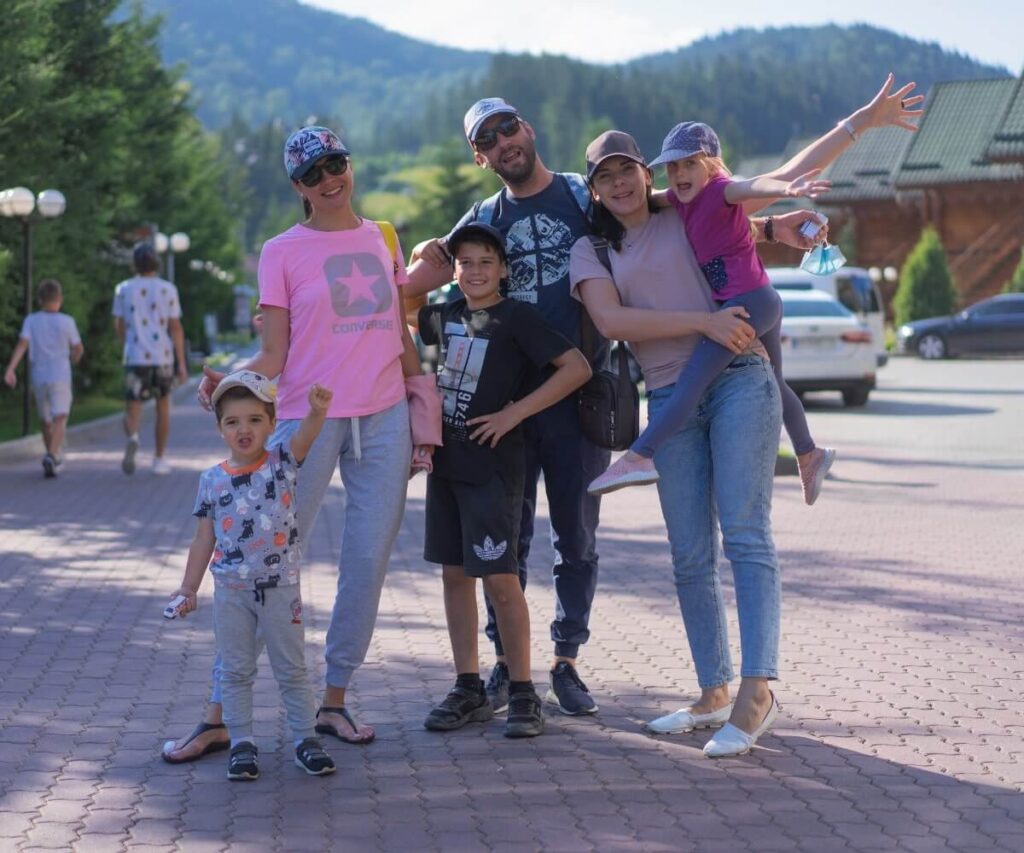 A happy family with young children posing together during their vacation in a Patagonian mountain village.