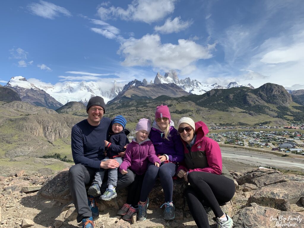 Family sitting on a rock during a nature hike in El Chalten