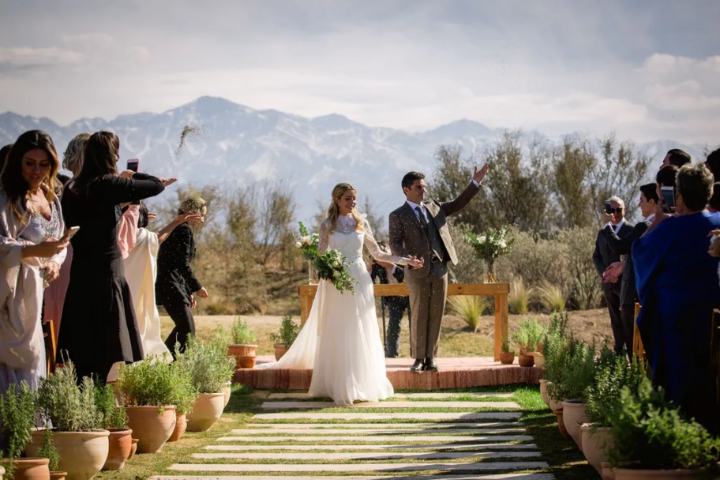 Outdoor luxury wedding reception setup at a Mendoza vineyard with mountain views