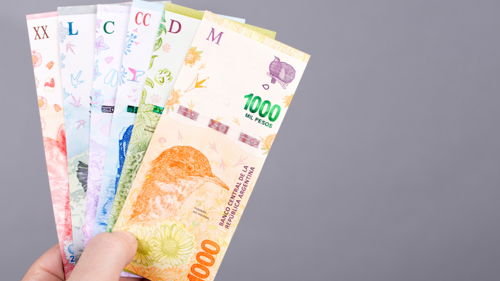 Do I Need Cash When Traveling To Argentina? Traveler holding cash asking how much money to bring to Argentina